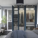 Modern blue wardrobe with clothes, shelves, drawers, slow close doors.