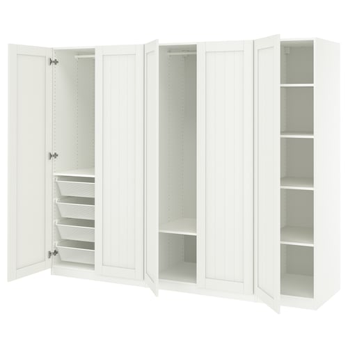 A white ikea PAX wardrobe with open doors, revealing shelves and drawers inside.