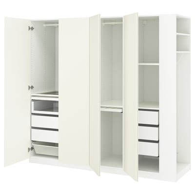 White PAX wardrobe, open, showing drawers, shelves, and hanging space.