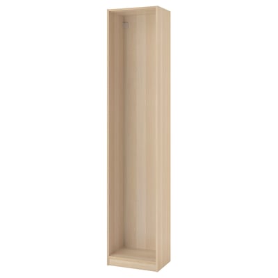 A PAX wardrobe frame in light oak. Its tall and rectangular with an open interior ready for organizers. The wood grain texture is visible.
