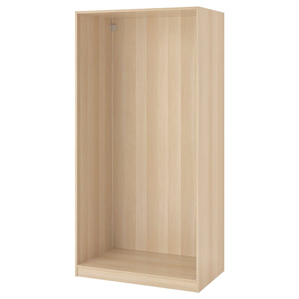 An ikea PAX wardrobe frame in white. It is rectangular with smooth surfaces and vertical grooves, designed for organizing bedroom essentials.