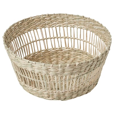 A round, handwoven basket named PENNFISK. Made from natural sedge, its ideal for bread or fruit, with a rustic, earthy design.