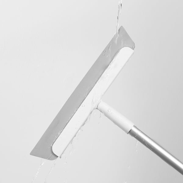 A silver squeegee with a white handle and water droplets, used for cleaning floors, removing hair, water, and dirt.