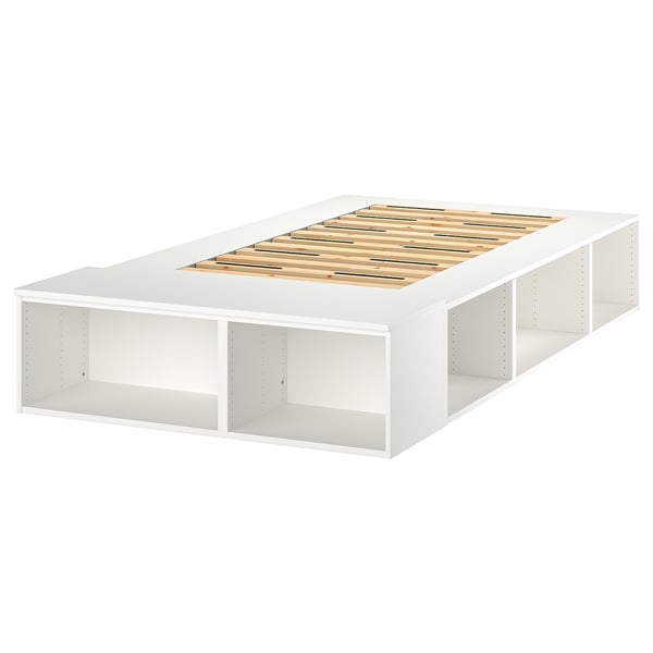 A white PLATSA bed frame with a slatted wooden base and open shelves on three sides.