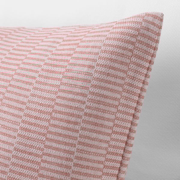 Close-up of rouge and white woven cushion cover, showing intricate striped pattern and quality cotton texture.