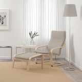 Pocoang armchair & footstool: lightwood, cream cushions; cozy, simple design; large, near window; lamp & decor beside.