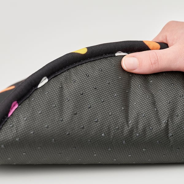 Hand holds soft, washable seat pad with zip and non-slip bottom.