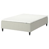 White RÅHOLMAR bed base with upholstered sides and black legs.