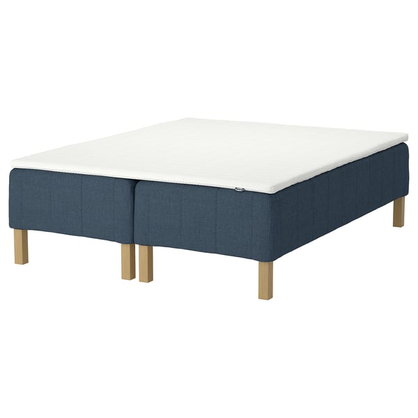 Displays the RÅHOLMAR bed base in blue, featuring a white mattress. The base has wooden legs, designed for easy assembly.