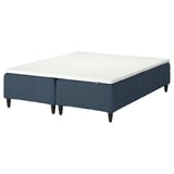 Displays an IKEA RÅHOLMAR bed in blue with a white mattress. It has four wooden legs, a sprung base, and a memory foam mattress pad for comfort.