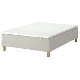 The RÅHOLMAR bed in white with wooden legs, featuring 5 comfort zones and a memory foam mattress pad.