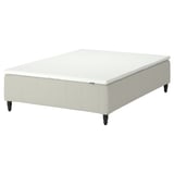 An IKEA RÅHOLMAR bed base in white with wooden legs.