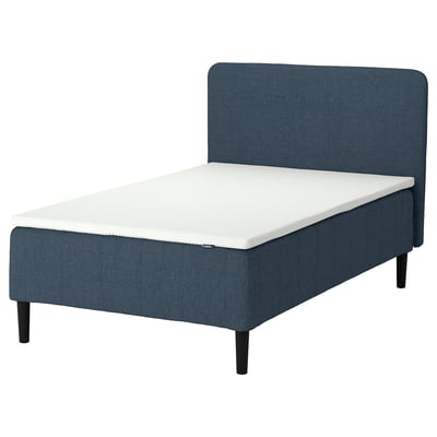 Blue upholstered bed with foam mattress, modern design, dark legs.