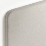 Close-up of plush headboard edge. Soft, smooth fabric and neat stitching indicate high-quality.