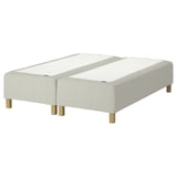 RÅHOLMAR bed base, light beige, wooden legs, upholstered, divided into 3 sections.