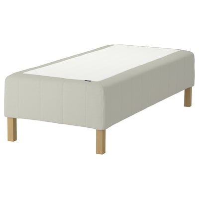 A white RÅHOLMAR mattress base with a rectangular shape and wooden legs, giving it a minimalist and modern design.
