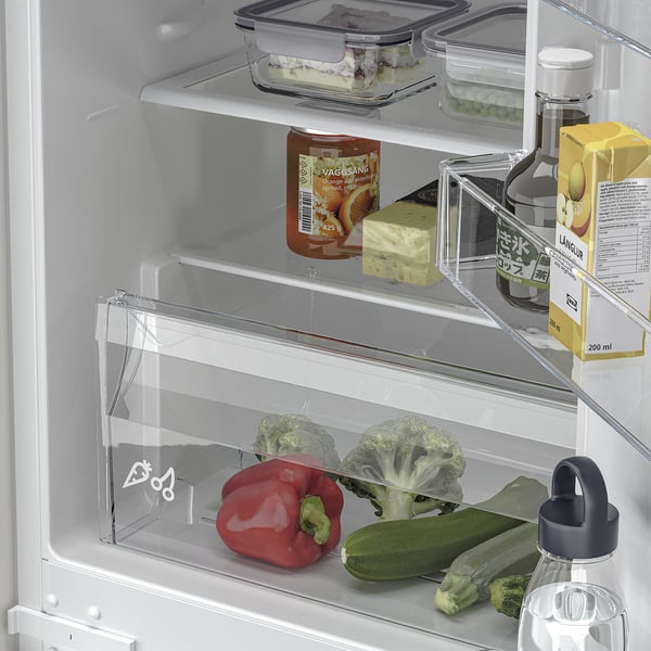 Organized fridge with adjustable shelves, veggies, drinks, and led lighting.