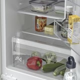 Organized fridge with adjustable shelves, veggies, drinks, and led lighting.