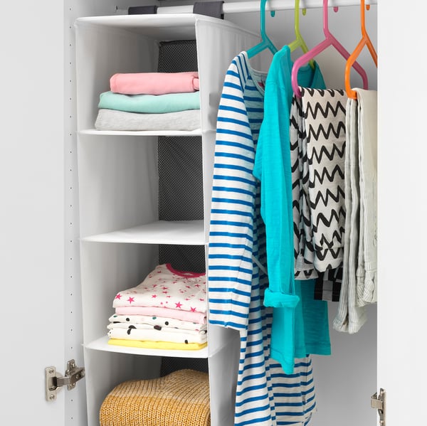 Hanging organizer with 5 compartments, storing colored clothes, ideal for kids.