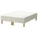 A RENFJÄLLET bed in white with wooden legs, featuring a upholstered rectangular base and mattress.