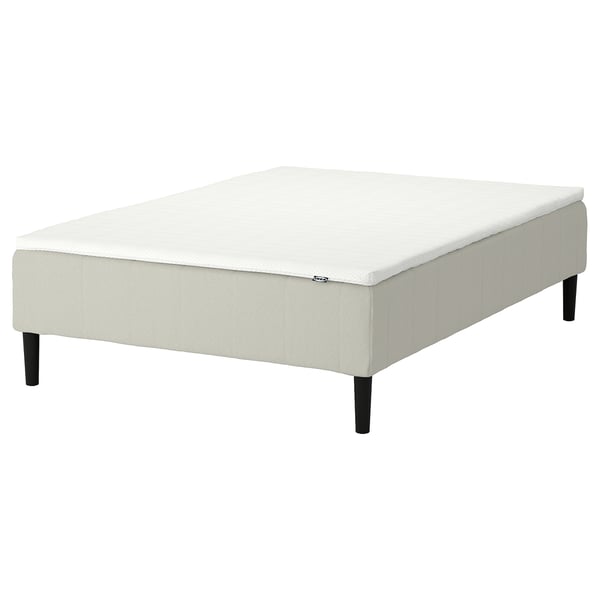 White upholstered bed base with wooden legs.