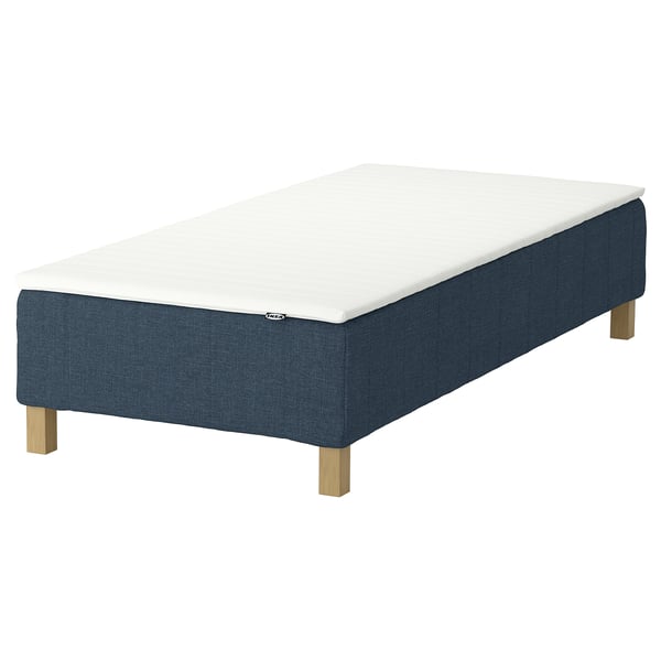 A blue rectangular bed base with wooden legs, topped with a white mattress. Scandi design, IKEA brand.