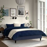 Modern bedroom with RENFJÄLLET bed, decor. Queen/king size bed, dark blue, white accents, wooden floor, window, mirror.