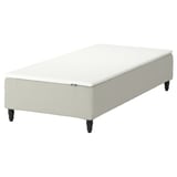An IKEA RENFJÄLLET white mattress on a beige base with black legs. It pocket springs for comfort and minimal motion transfer.