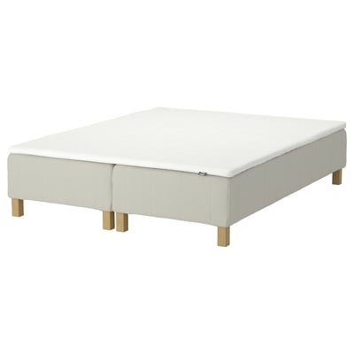 A light beige IKEA RENFJÄLLET bed base with wooden legs. Its rectangular with upholstered sides.