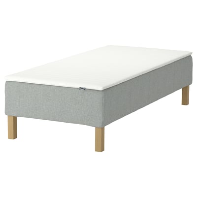 A light grey RENFJÄLLET mattress base with light wood legs and a white mattress, designed for motion isolation and easy assembly.