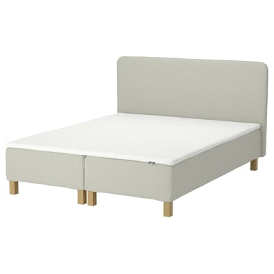 RENFJÄLLET bed in light beige, upholstered with light fabric and wooden legs, rectangular shape with padded headboard.
