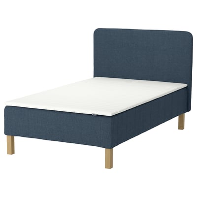 Blue fabric bed with white mattress, wooden legs, rectangular headboard.