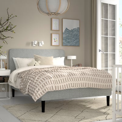 RENFJÄLLET bed with grey headboard, striped bedding, and rug. Perfect for small spaces. Includes teddy bear and night lamp.