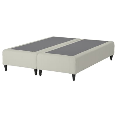 A RENFJÄLLET bed base in beige with black legs, featuring a modern and stylish design with pocket springs for comfort and motion isolation.