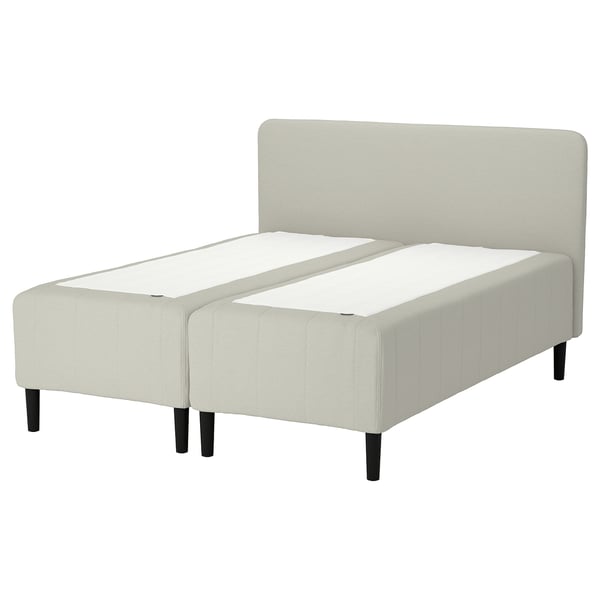 RISHÖJDEN bed: cream, upholstered, rectangular, plush, modern design with headboard, supported by dark wooden legs.