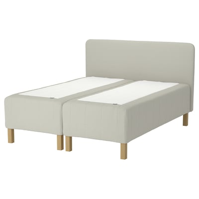 RISHÖJDEN twin bed in light beige fabric with wooden legs and high headboard.