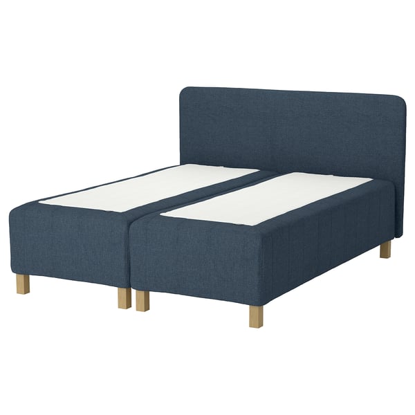 The RISHÖJDEN bed in blue fabric with wooden legs and a headboard.