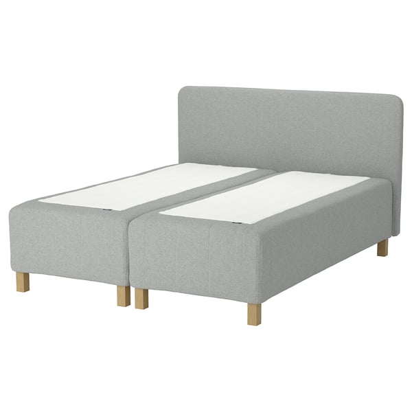 Modern grey upholstered bed with wooden legs and padded headboard.