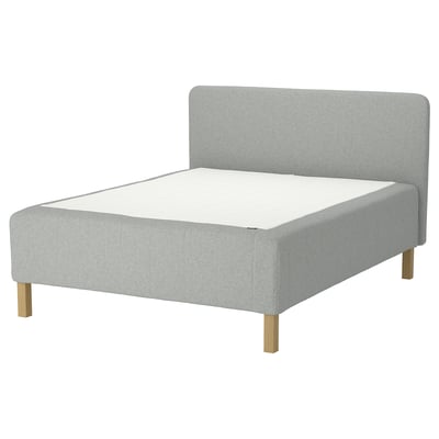 A light grey RISHÖJDEN bed with a soft headboard and wooden legs. Its designed with a modern style.