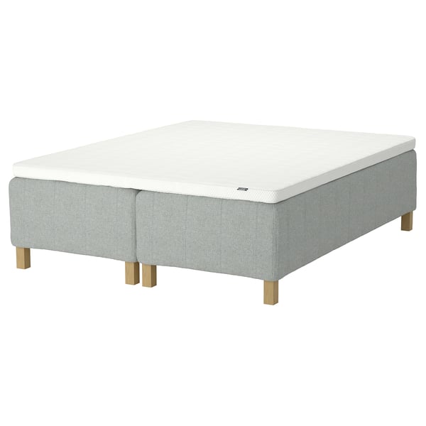 RISHÖJDEN bed with white mattress, grey fabric base, light wood legs.