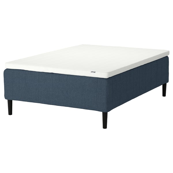 Blue fabric bed base with white mattress, wooden legs, modern design.