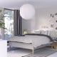 Modern bedroom featuring a RISHÖJDEN bed with white bedding and plant. Round pendant light, striped floor rug, and wall art.