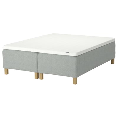 Rishojden bed: grey, rectangular, upholstered base, wooden legs, white mattress.