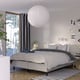 Modern bedroom with RISHÖJDEN white polka dot bed, pendant lamp, rug, striped curtains, plants.
