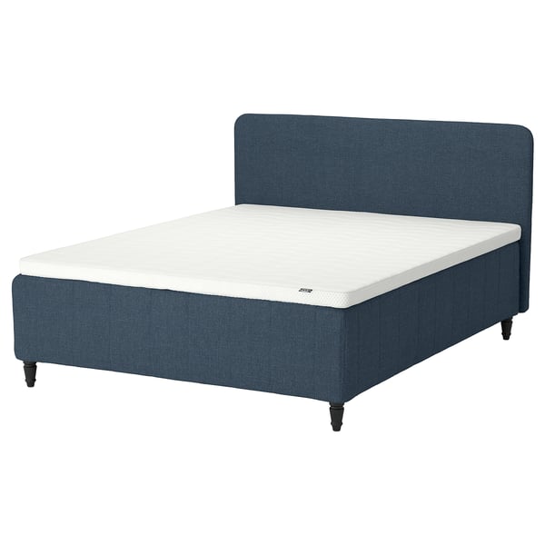 Blue RISHÖJDEN bed with foam mattress, upholstered headboard, dark wooden legs.