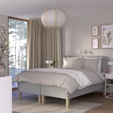 Grey RISHÖJDEN bed with nightstands, hanging light, and floral artwork.