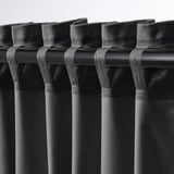 Black velvet curtains with tab headers, darkening room and adding elegance.