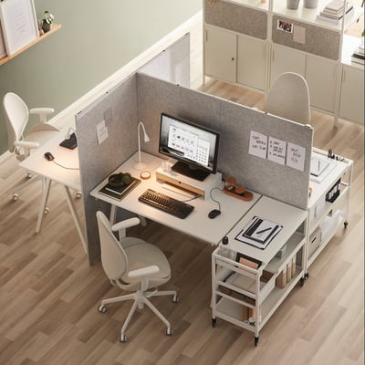 Minimalist workspace with gray SIDORNA dividers separating desk and chair, maintaining openness.