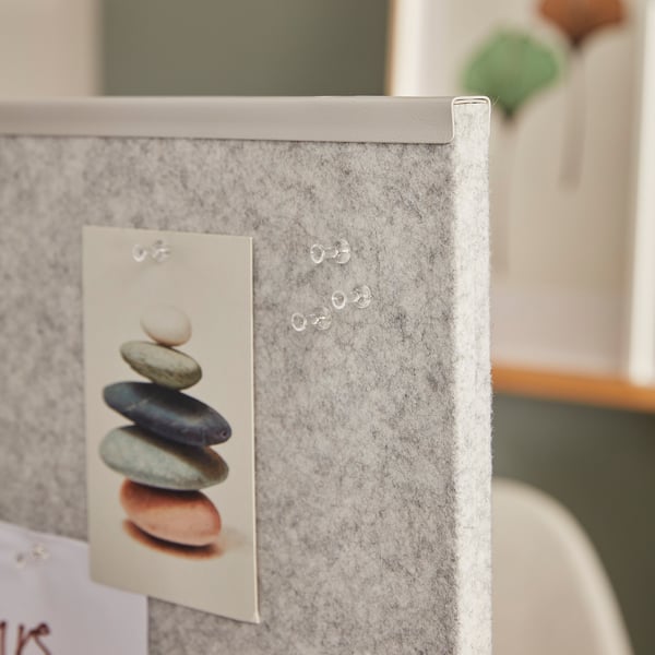 A room divider screen with notes pinned; used for creating spaces and organizing messages.