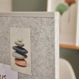A room divider screen with notes pinned; used for creating spaces and organizing messages.